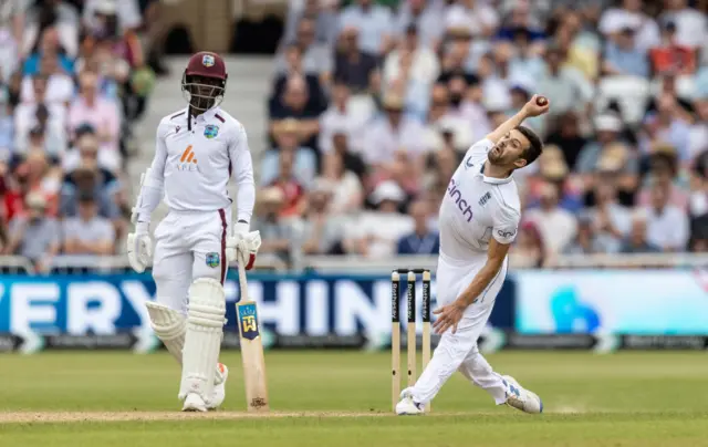 Shamar Joseph of West Indies looks on as Mark Wood of England bowls during day three of the 2nd Rothesay Test Match between England and West Indies at Trent Bridge