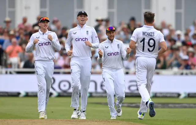 Chris Woakes of England celebrates with Harry Brook, Zak Crawley and Joe Root after dismissing Jason Holder of the West Indies during day three of the 2nd Test Match between England and the West Indies at Trent Bridge