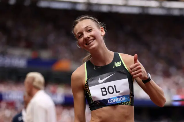 Femke Bol holds up her thumb and smiles