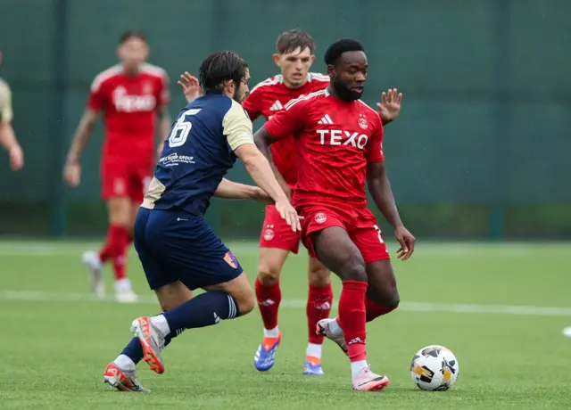 Aberdeen's Shayden Morris is closed down by East Kilbride's Jack Leitch