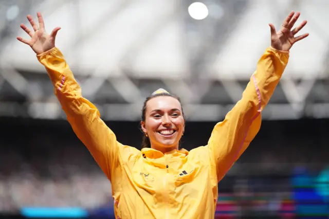 Mackenzie Little holds up her arms in celebration