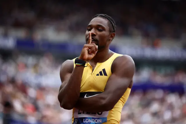 Noah Lyles holds his finger to his lips