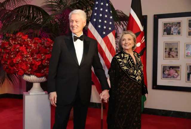 Bill and Hillary Clinton hold hands