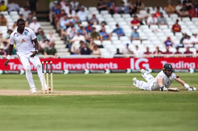 Gus Atkinson dives to make his ground