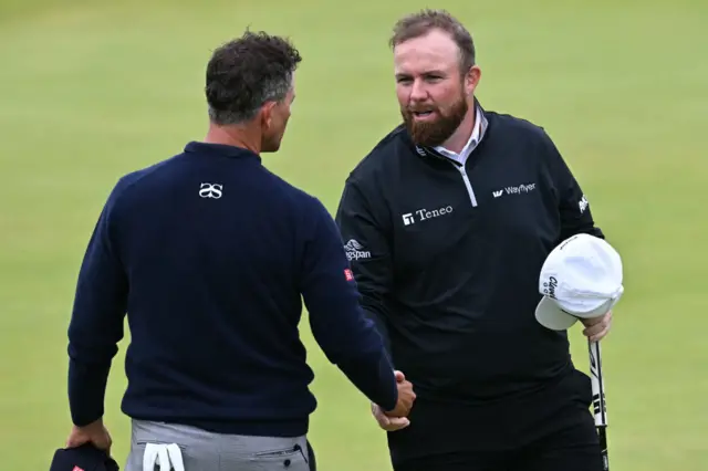 Shane Lowry shakes hands with Adam Scott