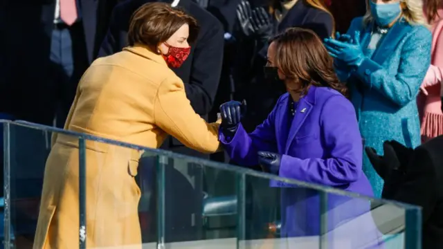 Klobuchar (left) and Harris greet during the presidential inauguration