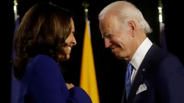 Kamala Harris and Joe Biden smile at each other in 2020, during the presidential election campaign