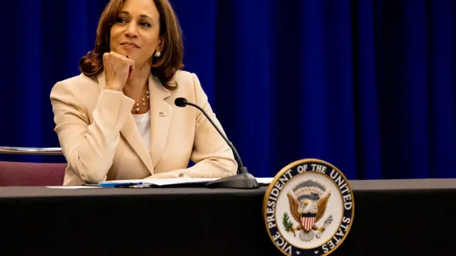 Kamala Harris sits at a table