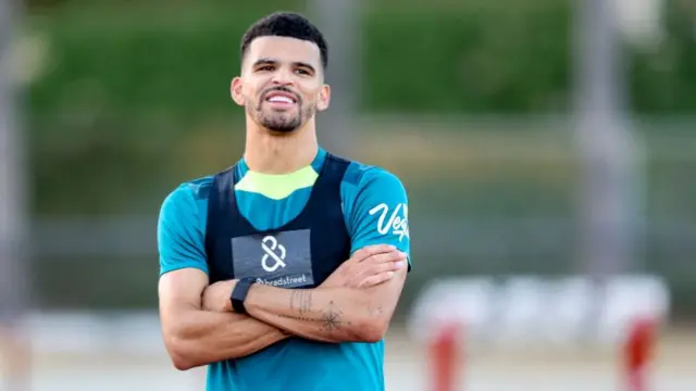 Dominic Solanke standing with his arms folded