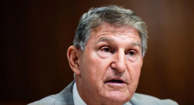 West Virginia Senator Joe Manchin pictured up close. He has greying hair, and looks to be in the middle of speaking.