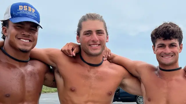 Three lifeguards from Delaware pose for a photo