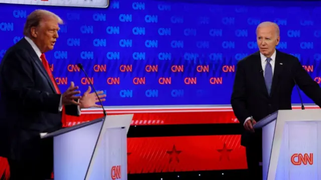 Democrat presidential candidate U.S. President Joe Biden listens as Republican presidential candidate and former U.S. President Donald Trump speaks during their debate in Atlanta, Georgia