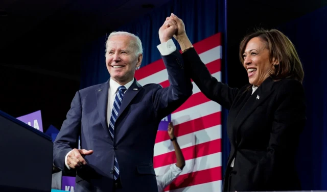 US President Joe Biden and Vice President Kamala Harris stand on stage together after delivering remarks at the DNC 2023