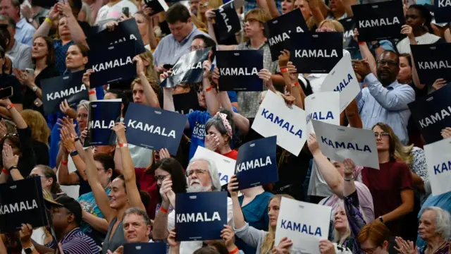 Supporters of U.S. Vice President Kamala Harris hold campaign signs as they attend a campaign event at West Allis Central High School, in West Allis, Wisconsin, U.S., July 23, 2024.