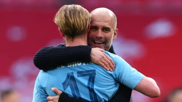 Pep Guardiola hugs Kevin de Bruyne