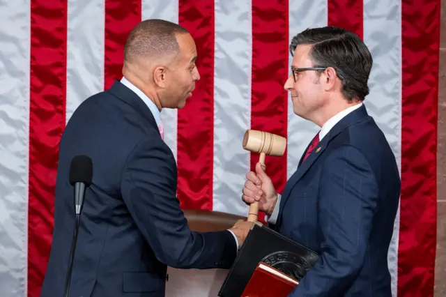 Hakeem Jeffries hands a gavel to Mike Johnson in the House of Representatives