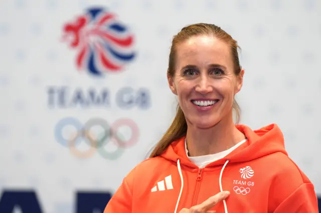 Helen Glover points to the Olmpic rings on her chest