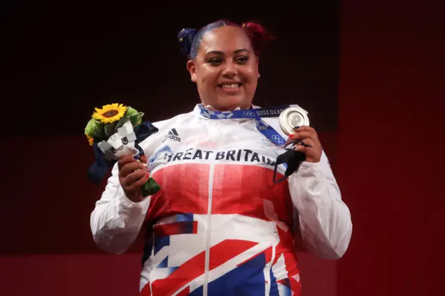 Emily Campbell holds up her silver medal and flowers