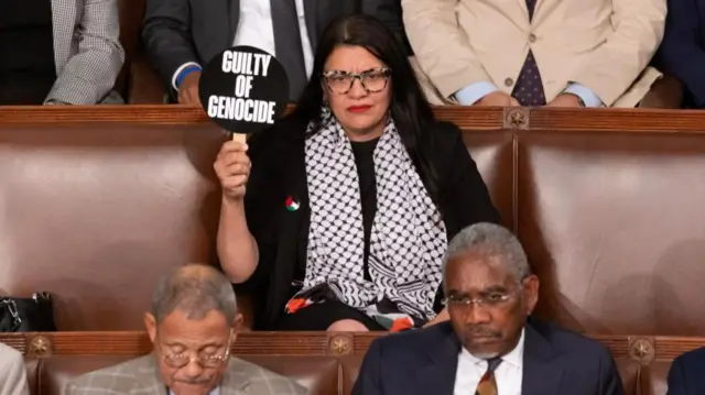 Tlaib with the sign