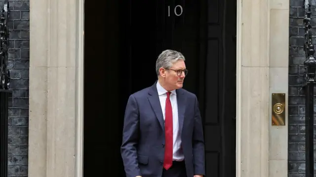 British Prime Minister Keir Starmer walks to welcome Jordan's King Abdullah (not pictured), at Downing Street, in London