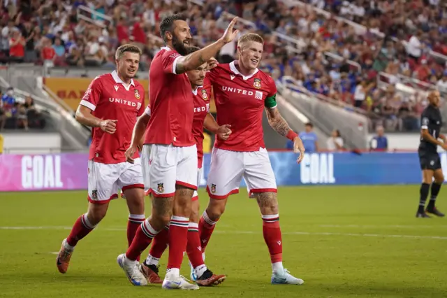 Wrexham midfielder Luke Bolton celebrates with forward Ollie Palmer and midfielder James McClean after scoring during the second half