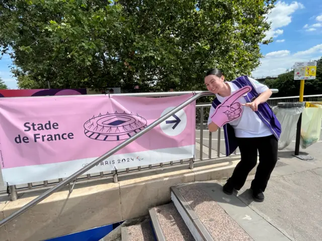 Parisian volunteer Melissa points the way to the Stade de France