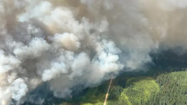 Smoke rises from the CWF057 wildfire west of Water Valley, Alberta, Canada in a photograph released July 24, 2024.