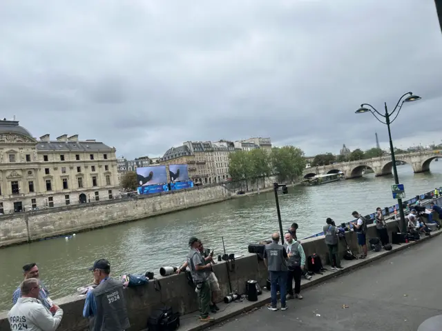 Photographers line the river Seine