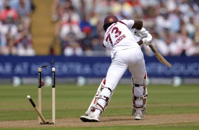 Kirk McKenzie is bowled by Mark Wood