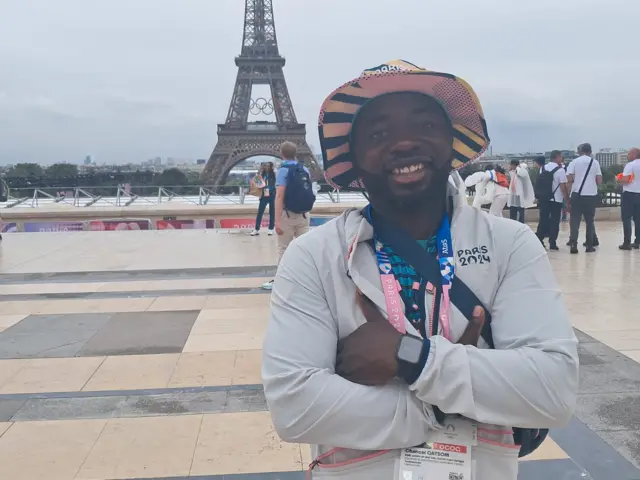 Chancel Gatsoni poses in front of the Eiffel Tower