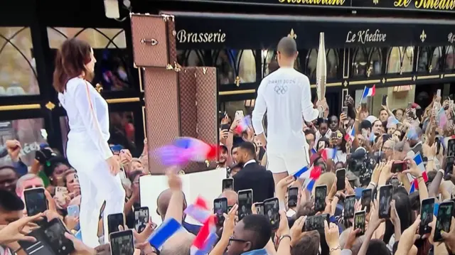 Laetitia Casta and Pharrell Williams with the Olympic torch