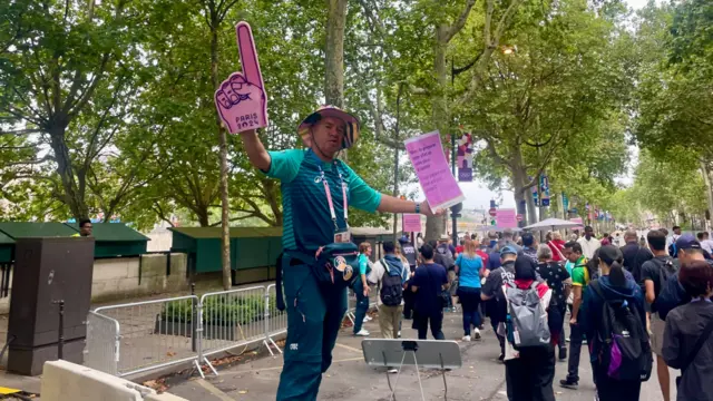 A volunteer waving a foam hand