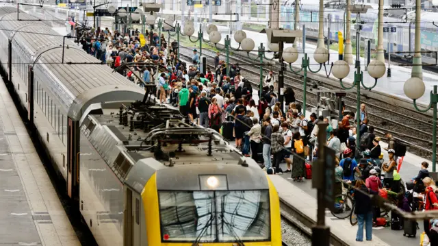 Stranded passengers wait inside Gare du Nord station in Paris,