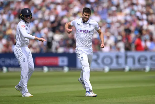 Mark Wood celebrates the wicket of Kirk McKenzie