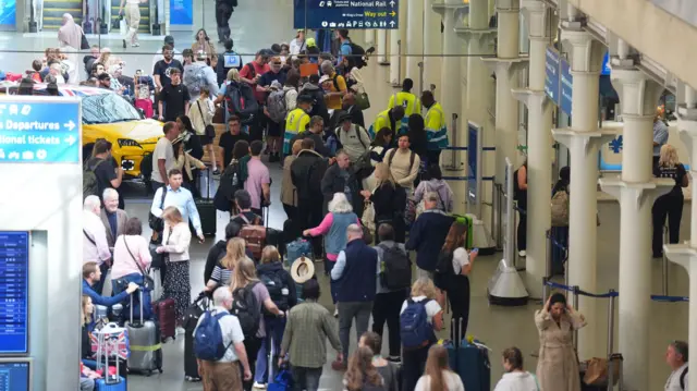 Overhead shot passengers queuing in St Pancras