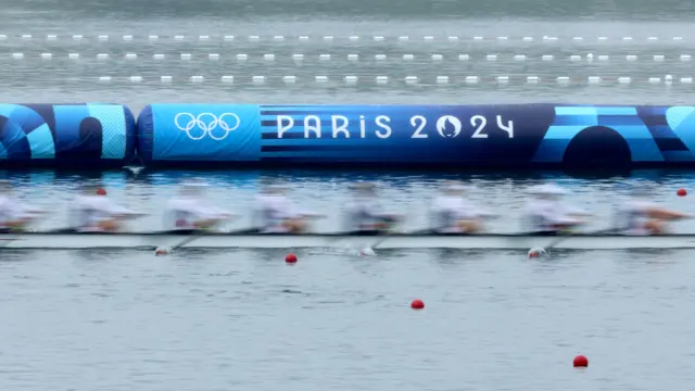 Inflatable barrier on the water says Paris 2024