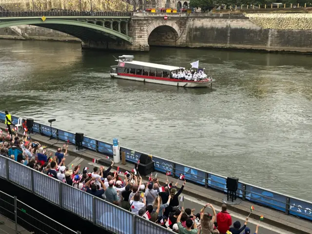 Athletes wave to the French crowds