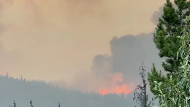 Smoke rises from a wildfire burning in Jasper, Alberta, Canada