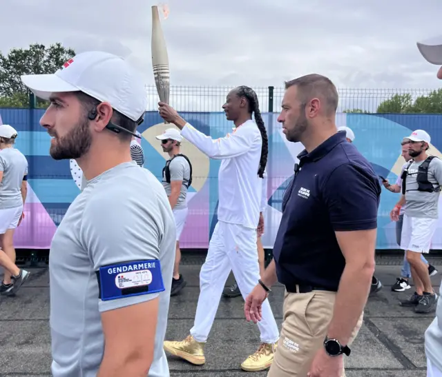 Snoop Dogg carries the Olympic torch through Paris