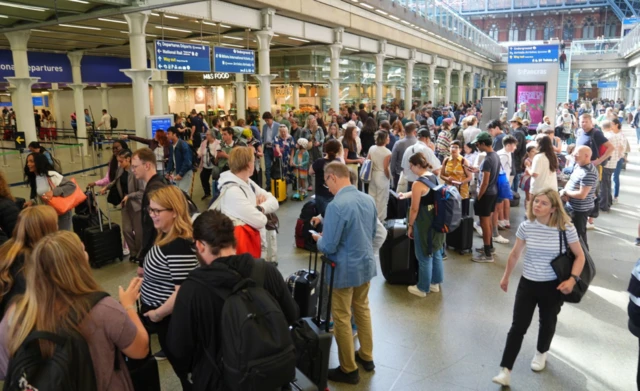 Passengers queue at the Eurostar terminal at St Pancras station in central London. French rail officials say several lines have been hit by "malicious acts" which have heavily disrupted services ahead of the Olympics