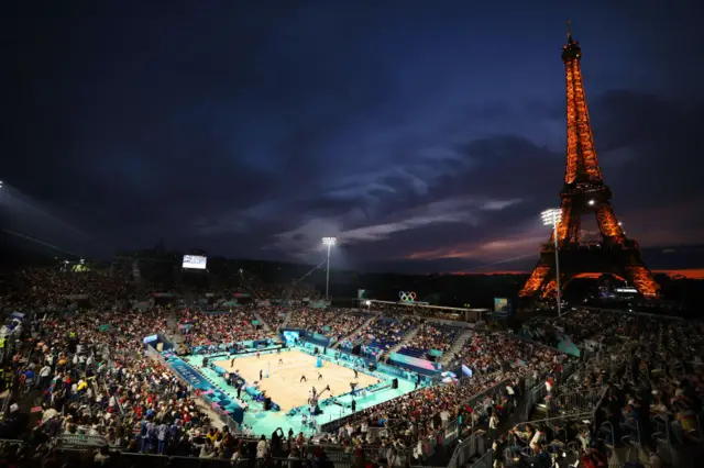 A general view of the Eiffel Tower and the beach volleyball court