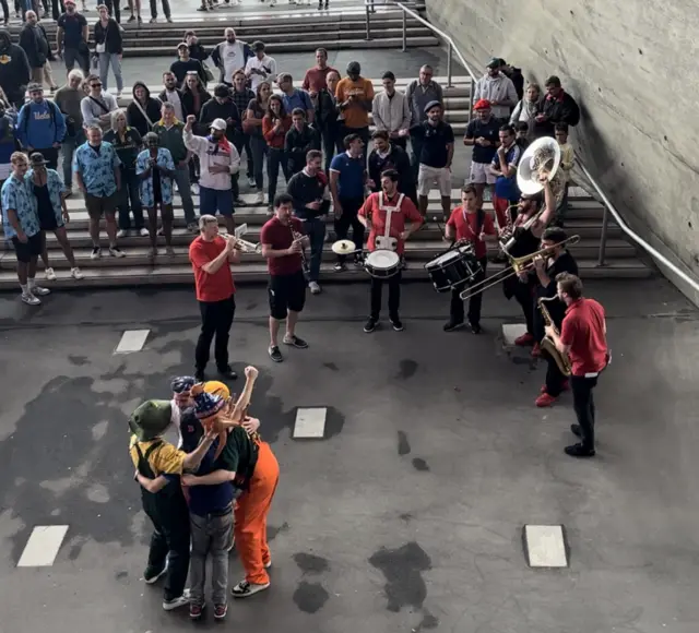 Fans dance in front of a band