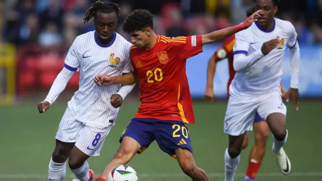 Valentin Atangana of France in action against Rayane Belid of Spain during the UEFA European U19 Championship group stage match.