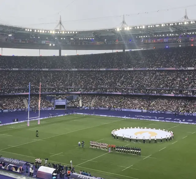 Teams line up for national anthems