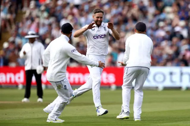 Chris Woakes celebrates the wicket of Kraigg Brathwaite