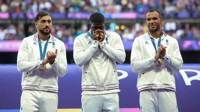 Gold medallists Rayan Rebbadj of France, Andy Timo of France and Varian Pasquet of France celebrate on the podium as they are presented with their medals