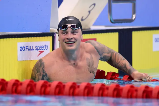 Adam Peaty smiling in the swimming pool