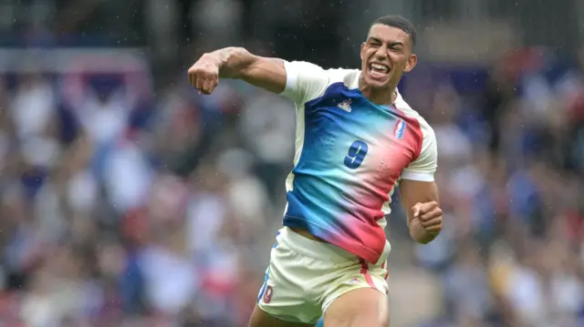 Aaron Grandidier jumps for joy after France beat South Africa in the Paris 2024 Olympic rugby sevens