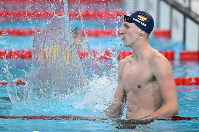 Lukas Maertens splashes the water in delight after winning gold