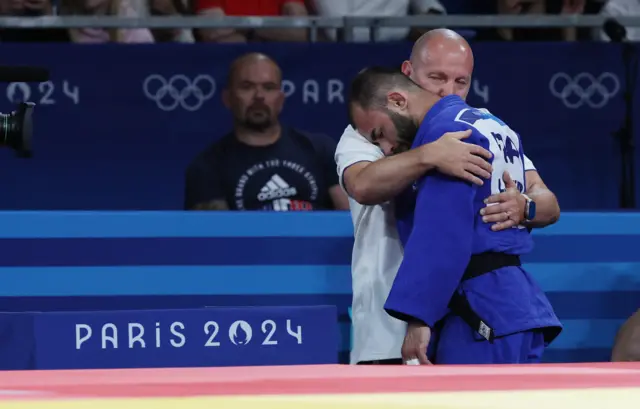 Mkheidze hugs his coach after losing the Judo men's final